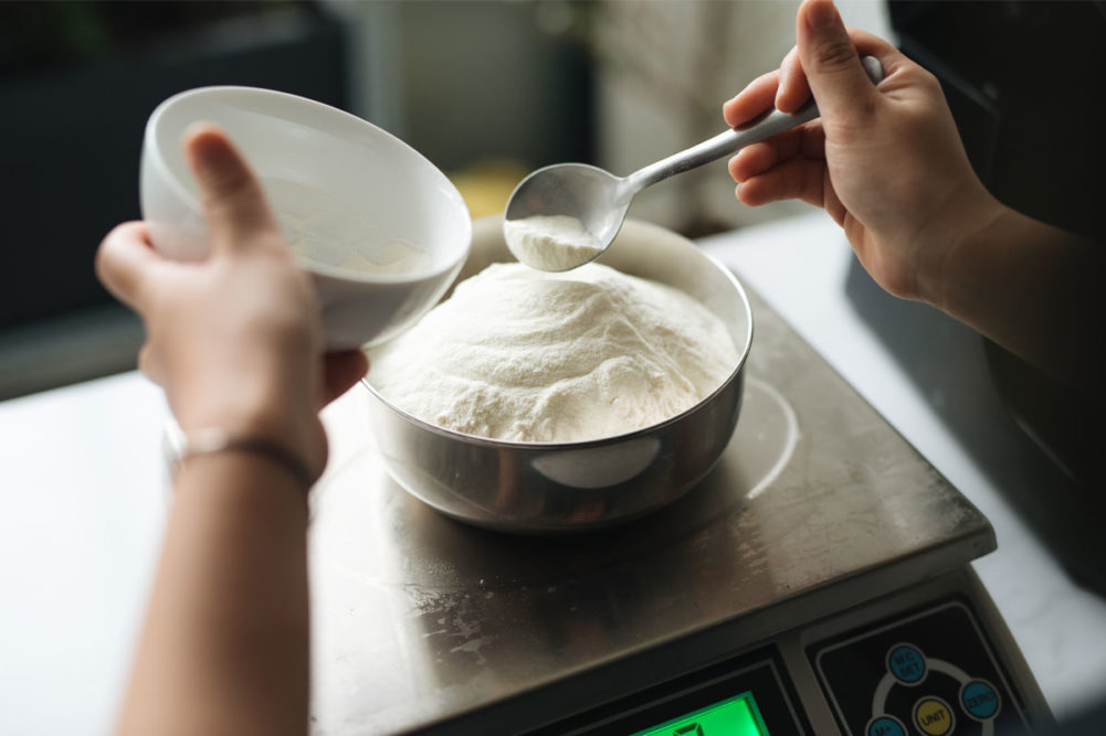 Chef weighing flour on a scale