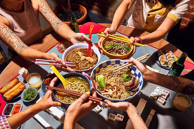 Group of people having dinner with immi