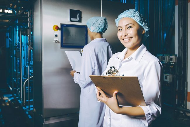 Woman working at a milk production line