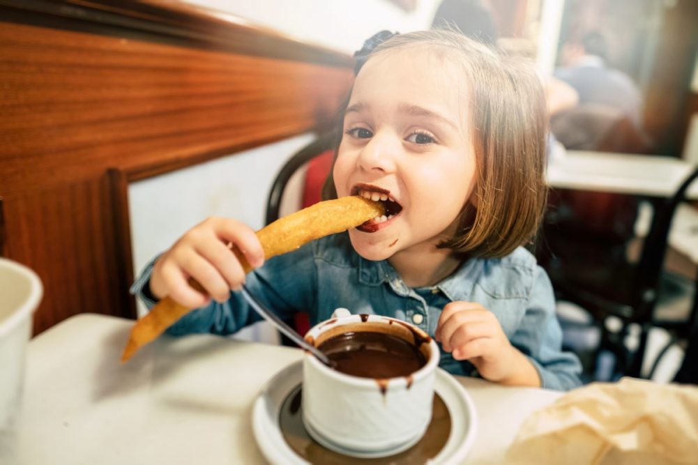 Child eating a churro