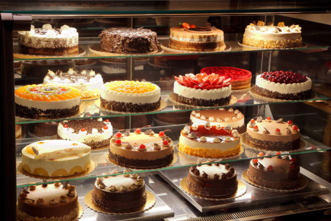 Different types of cakes in a pastry case