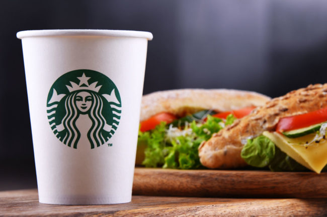 Starbucks coffee cup with a sandwich