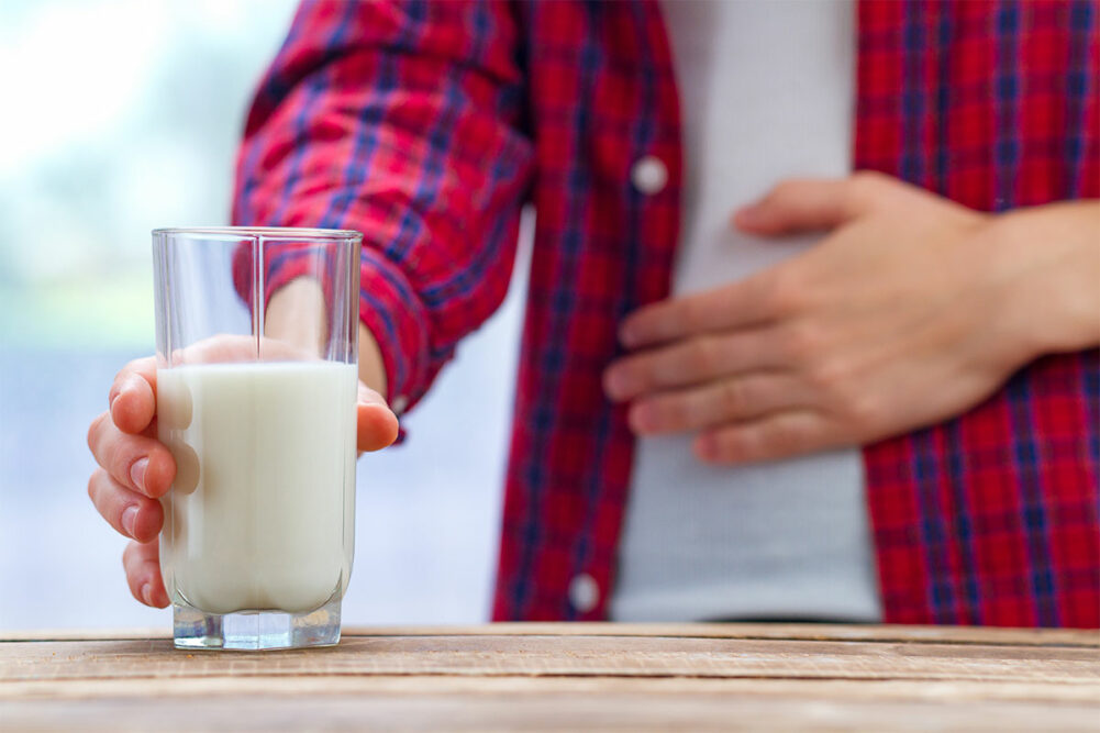 Man holding his stomach after drinking milk