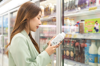 Woman examining a label in a grocery store