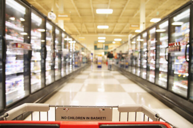 A shopping cart in the frozen aisle