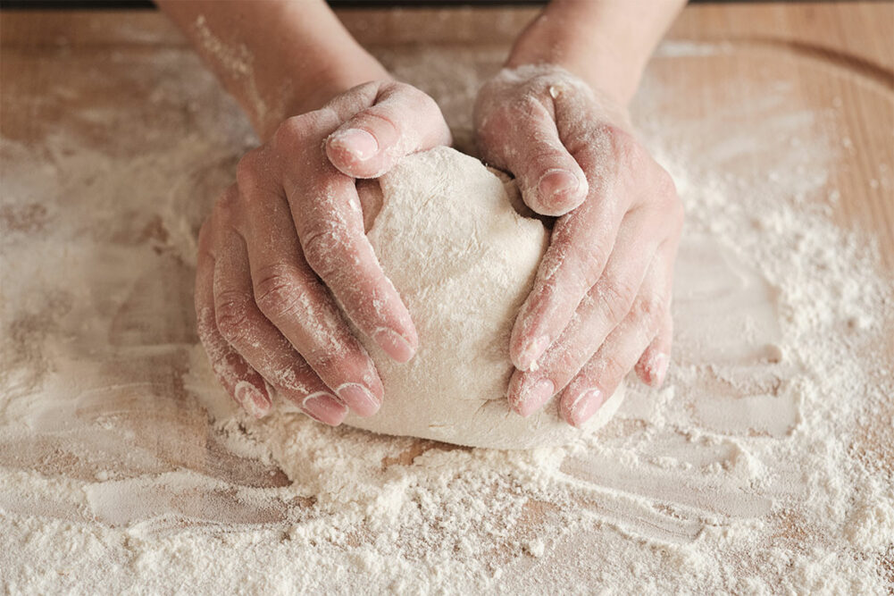 Person rolling out flour