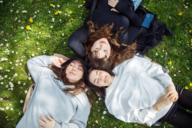 Group of women laying in a field