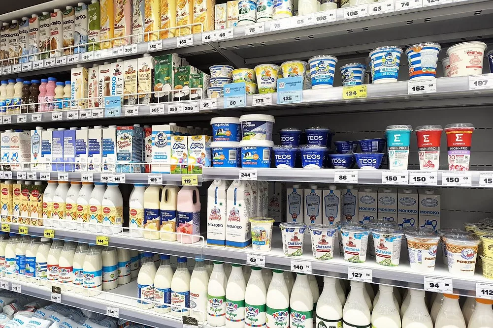 Variety of dairy products displayed on supermarket shelves