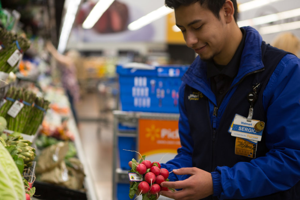 Walmart associate picking produce