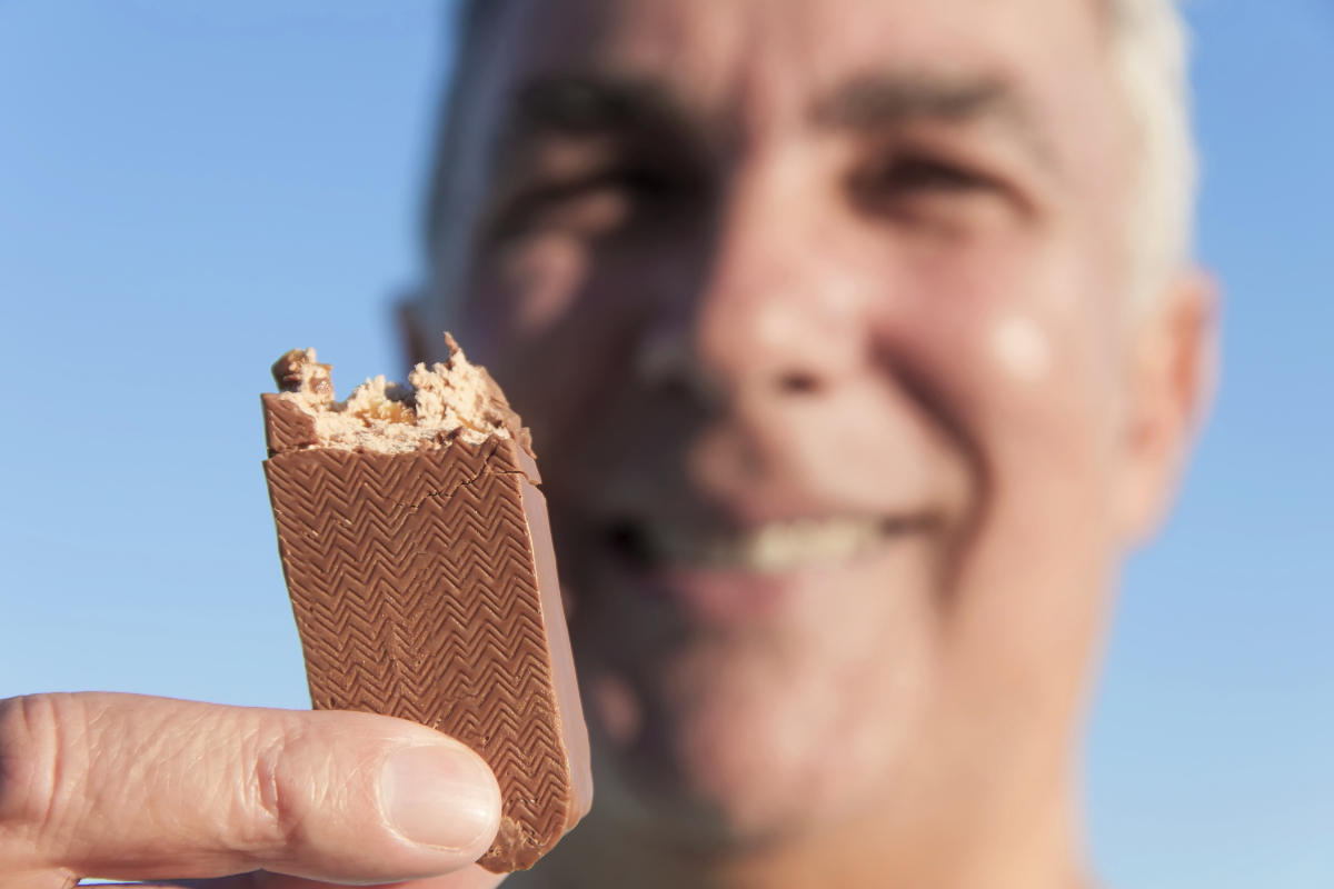 Old man eating candy bar