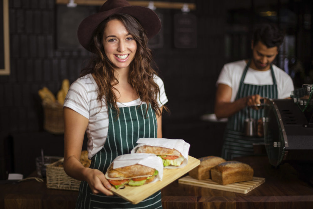 Barista with sandwiches