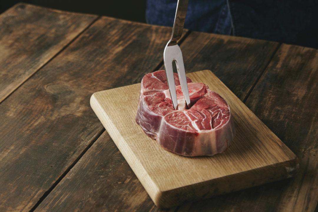 Stabbing steak with fork